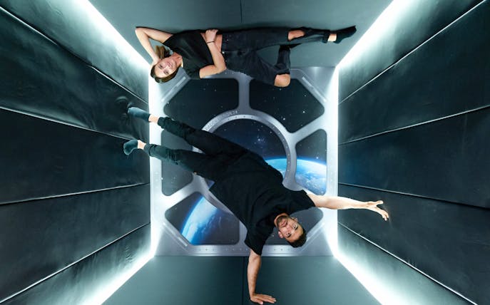 Visitors experiencing gravity-defying room at Paradox Museum Barcelona.