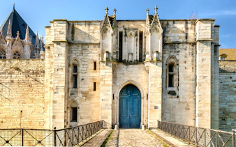 Château de Vincennes entrance with stone walls and blue door, Paris, France.