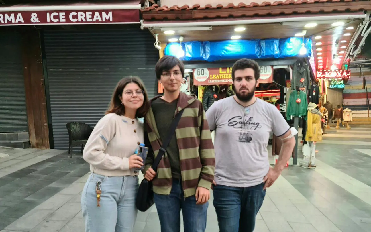 Group exploring Kusadasi street with shops during Ottoman culture self-guided tour.