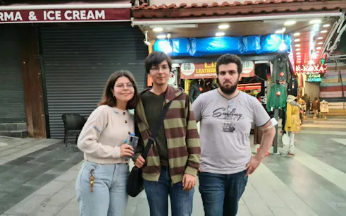 Group exploring Kusadasi street with shops during Ottoman culture self-guided tour.