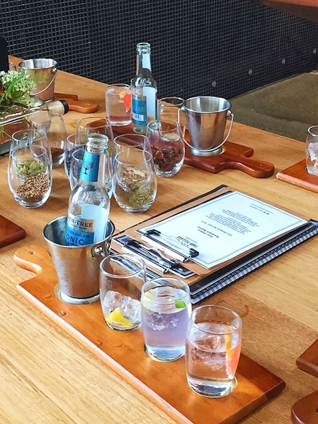 Wine tasting setup with glasses and bottles on a wooden table in Yarra Valley.