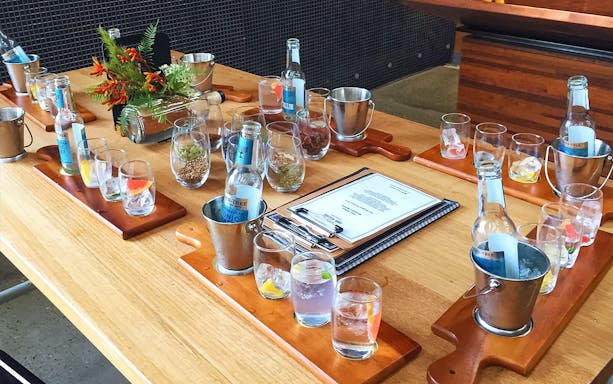 Wine tasting setup with glasses and bottles on a wooden table in Yarra Valley.