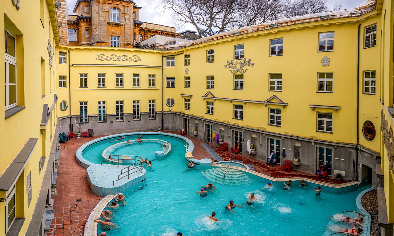 Visitors enjoying the outdoor pool at Lukács Thermal Bath, Budapest.