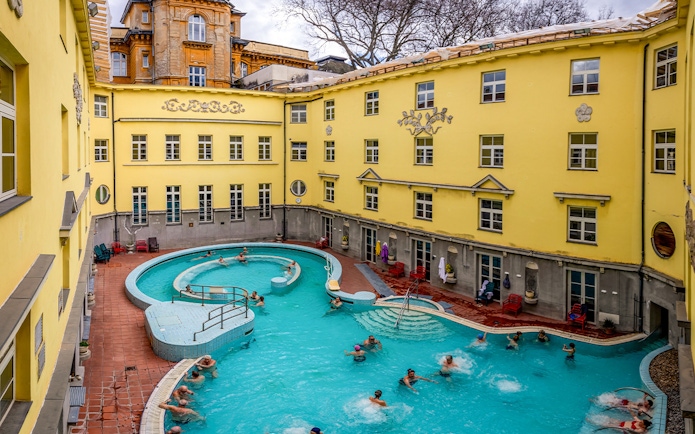 Visitors enjoying the outdoor pool at Lukács Thermal Bath, Budapest.