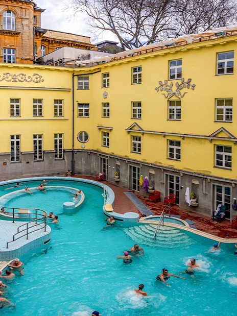 Visitors enjoying the outdoor pool at Lukács Thermal Bath, Budapest.