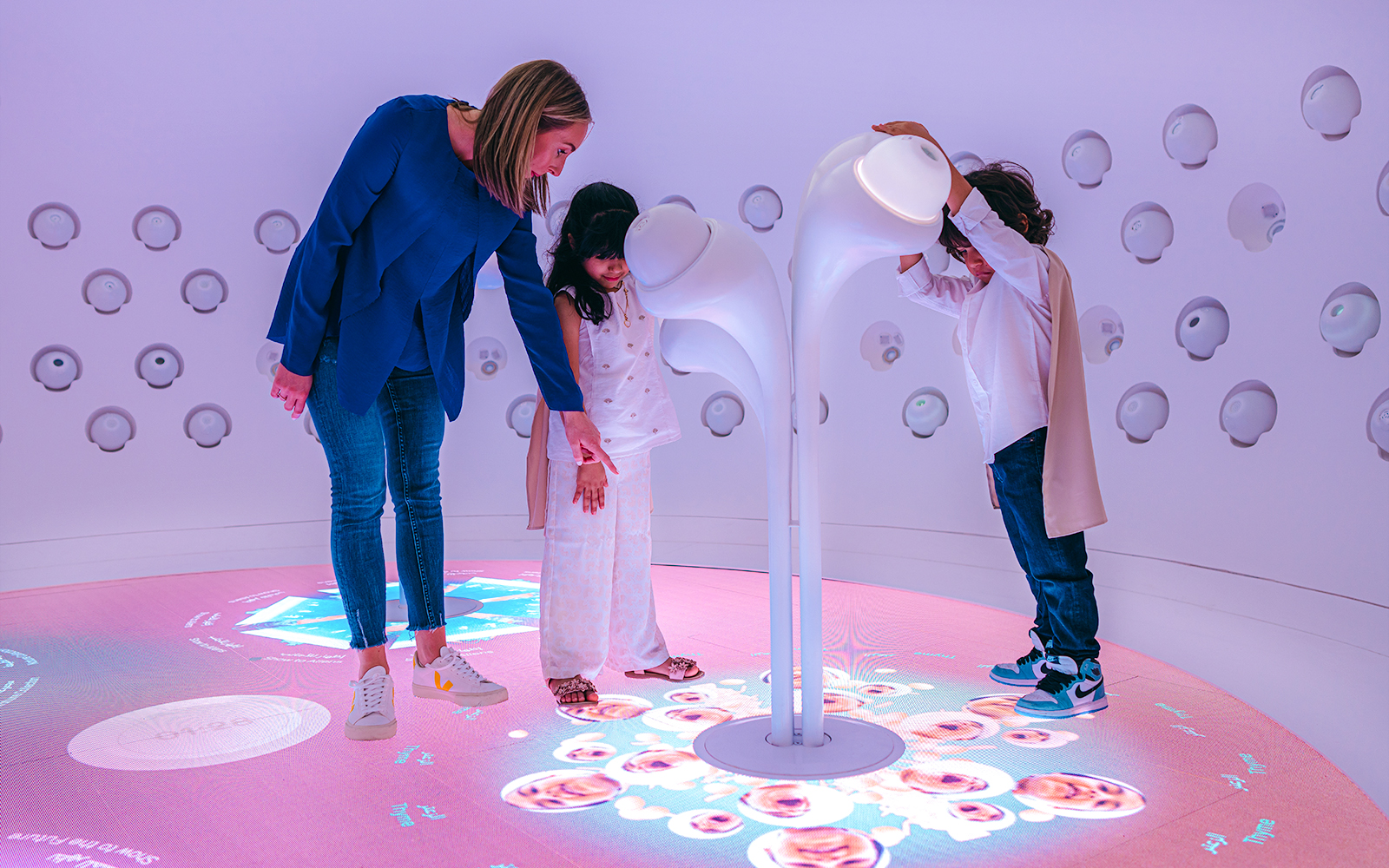 Children interacting with futuristic exhibit at Museum Of The Future, Dubai.