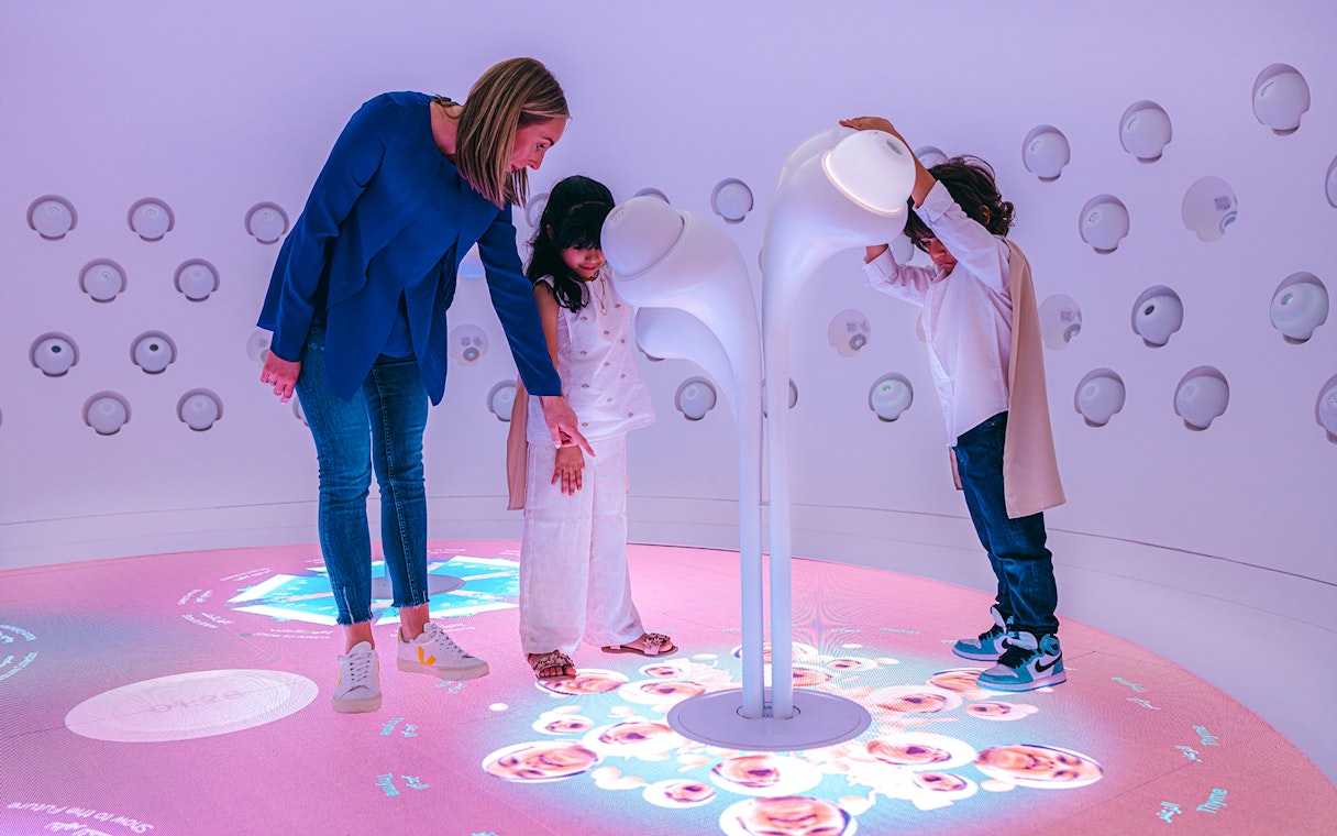 Children interacting with futuristic exhibit at Museum Of The Future, Dubai.