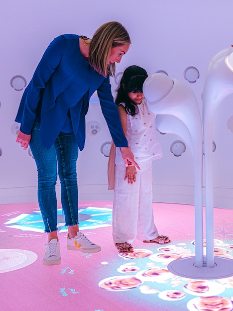 Children interacting with futuristic exhibit at Museum Of The Future, Dubai.