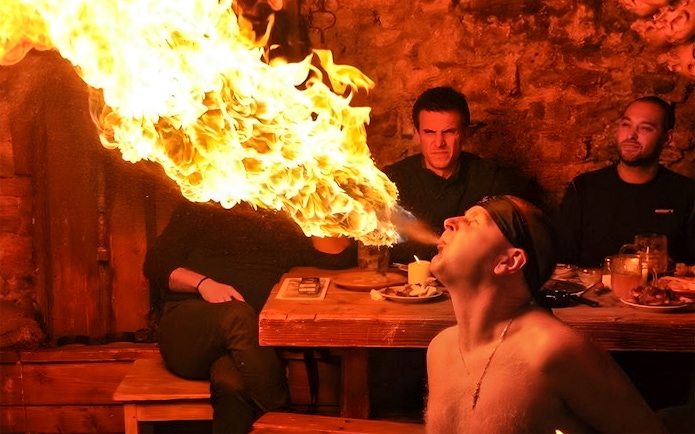 Fire breather performing at a medieval dinner show in Prague.