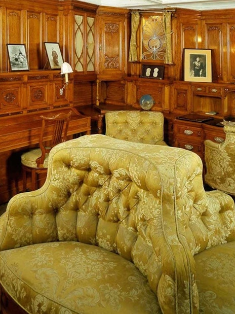 Maritime Museum Lisbon interior with ornate wood paneling and vintage furniture.