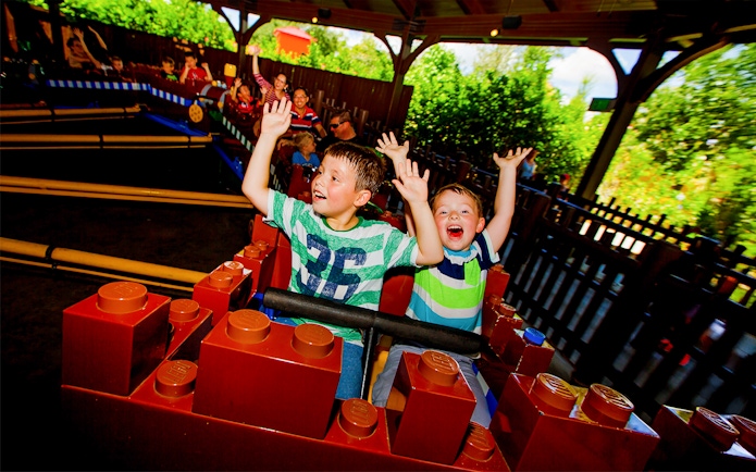 Children enjoying Merlin's Challenge ride at LEGOLAND Theme Park, Florida.