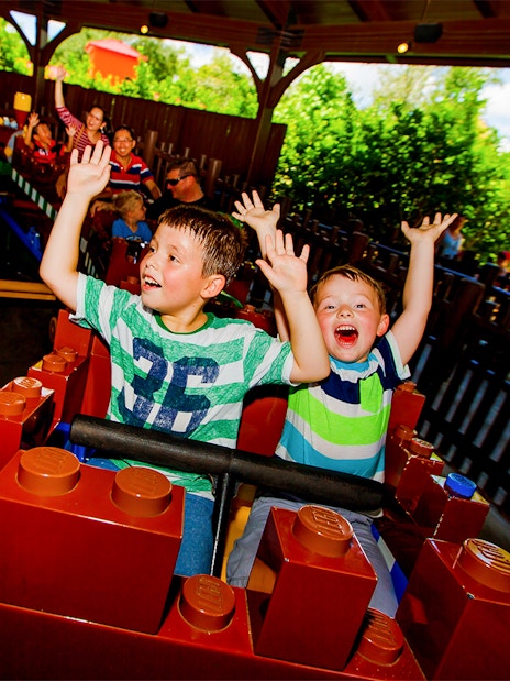 Children enjoying Merlin's Challenge ride at LEGOLAND Theme Park, Florida.