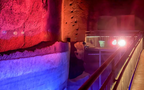 Underground passage with colorful lighting at LAPIS Museum, Naples.