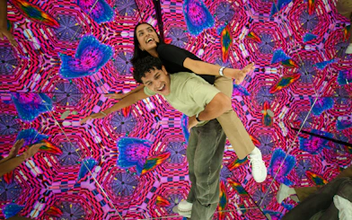 Visitors enjoying a vibrant kaleidoscope room at House Of Hype.