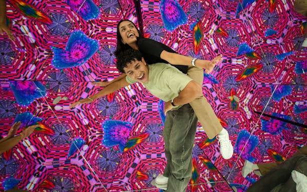 Visitors enjoying a vibrant kaleidoscope room at House Of Hype.