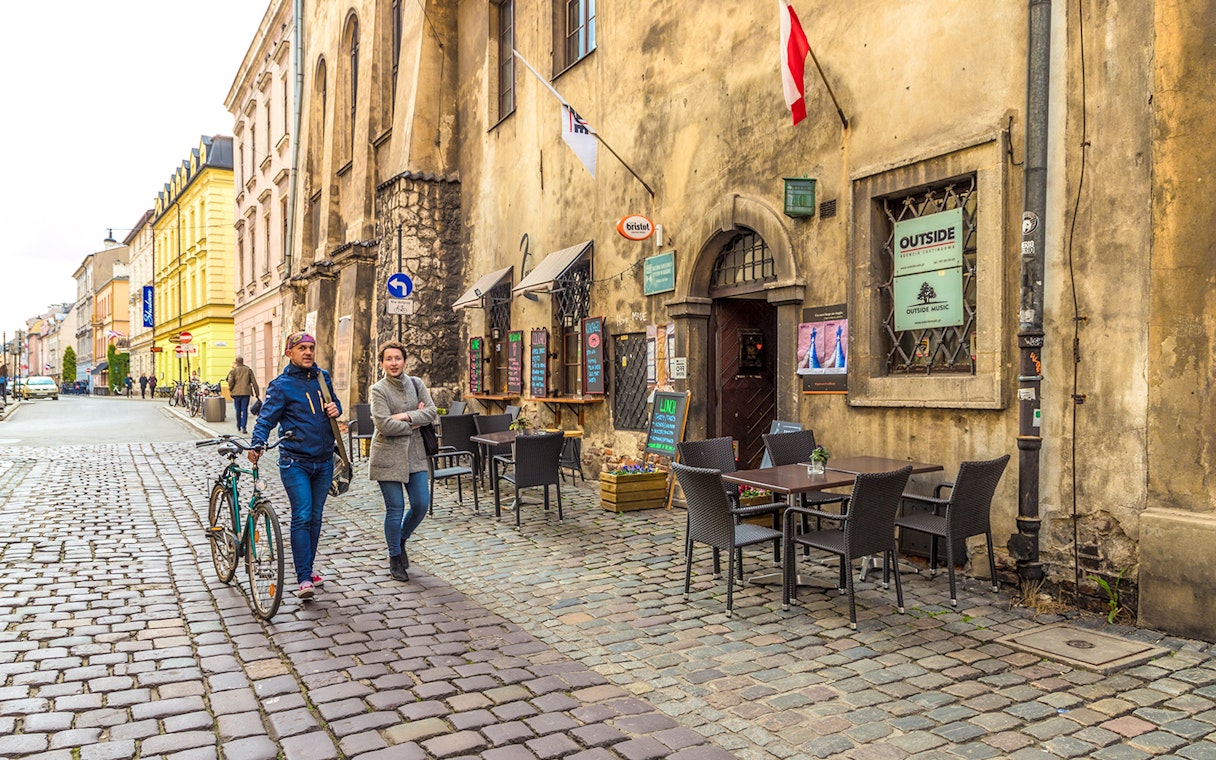 Krakow Jewish Ghetto street with historical buildings and cobblestone path.