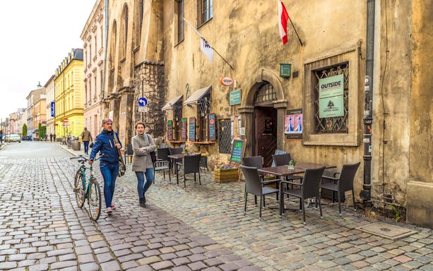 Krakow Jewish Ghetto street with historical buildings and cobblestone path.