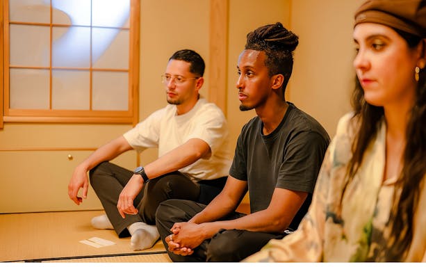 Tourists participating in a private tea ceremony in a traditional Japanese room.