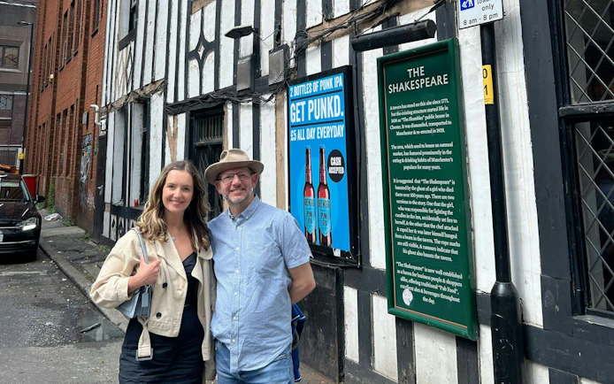 Visitors outside The Shakespeare pub in Manchester during a self-guided city exploration game.