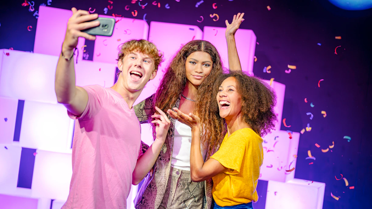 Visitors taking a selfie with Zendaya wax figure at Madame Tussauds London.
