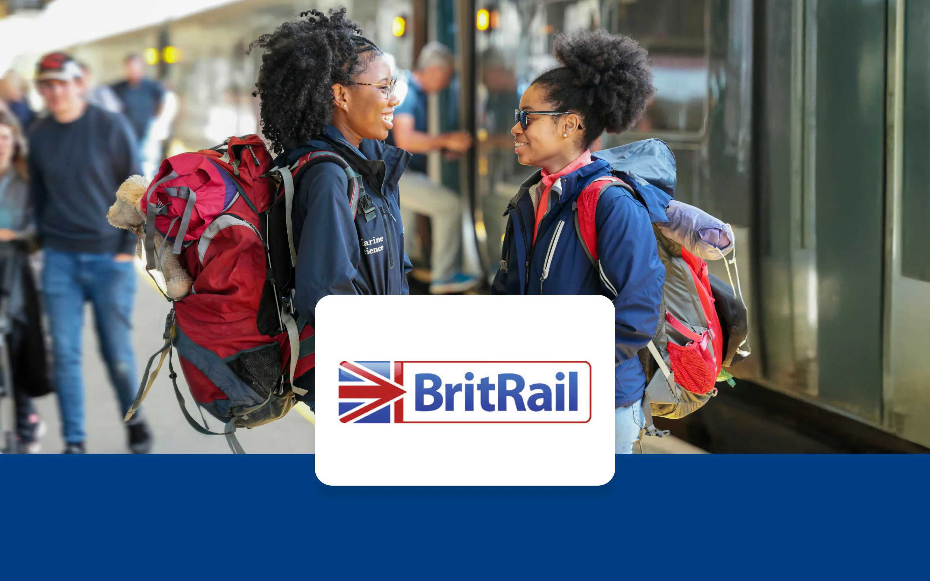 Travelers with backpacks at a train station platform in Europe.