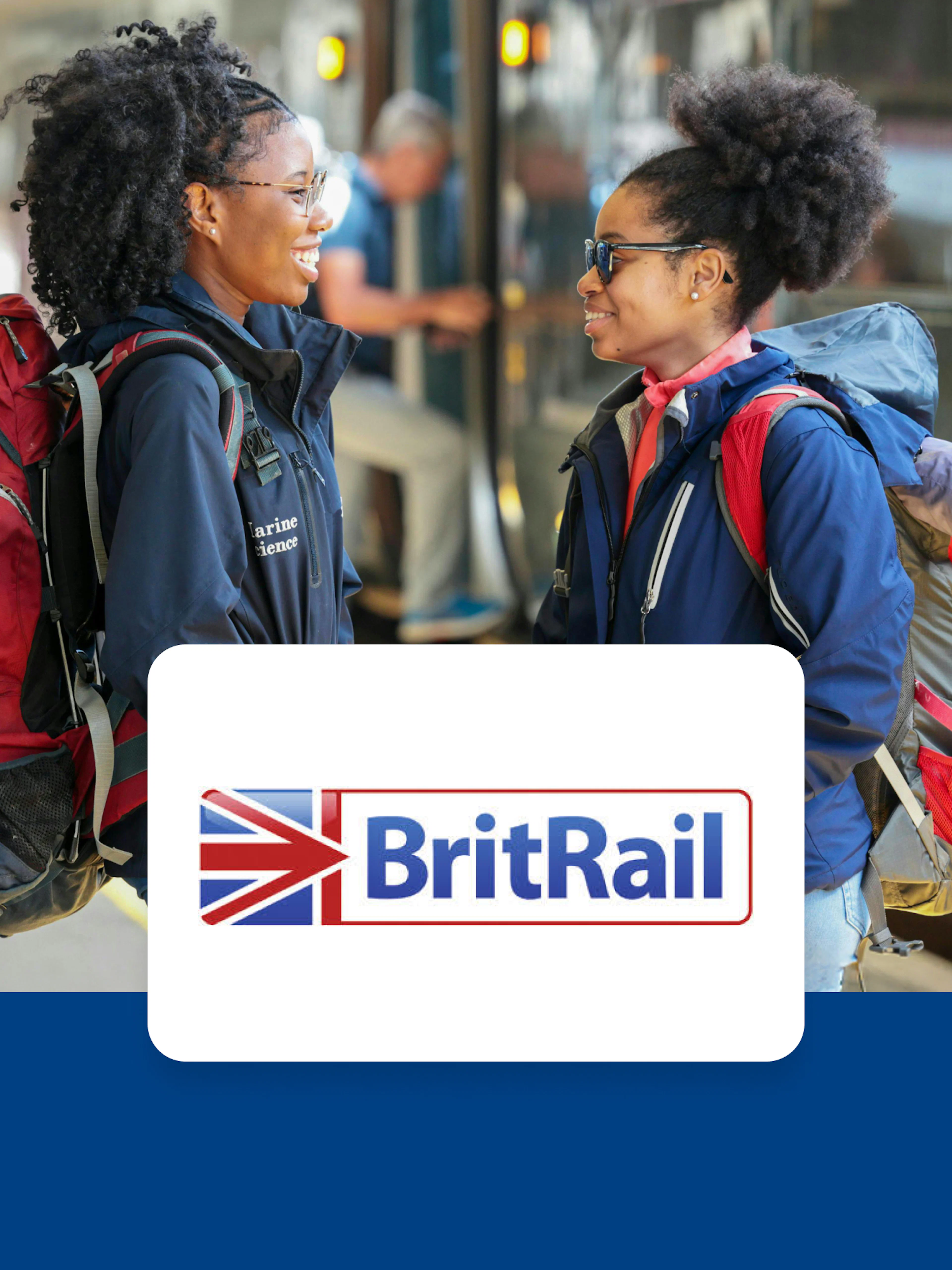 Travelers with backpacks at a train station platform in Europe.