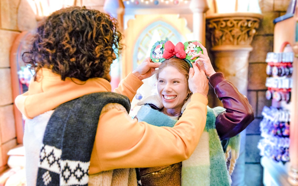 Guests enjoying Disneyland Christmas 2025 with festive Mickey Mouse ears.
