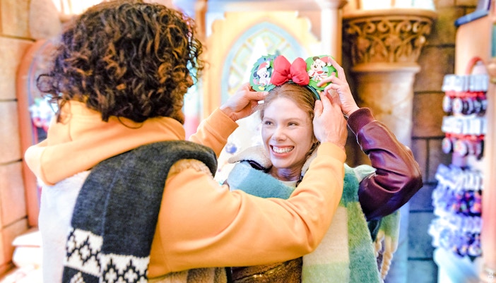 Guests enjoying Disneyland Christmas 2025 with festive Mickey Mouse ears.