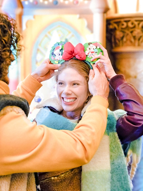 Guests enjoying Disneyland Christmas 2025 with festive Mickey Mouse ears.