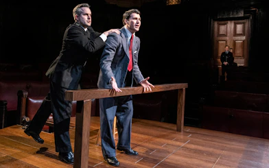 Courtroom scene from "Witness for the Prosecution" performance with actors in dramatic pose.