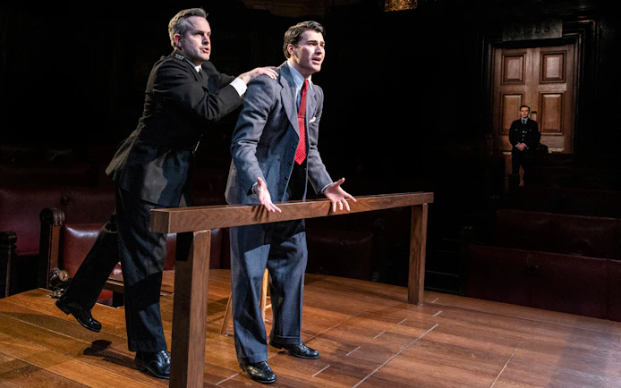 Courtroom scene from "Witness for the Prosecution" performance with actors in dramatic pose.