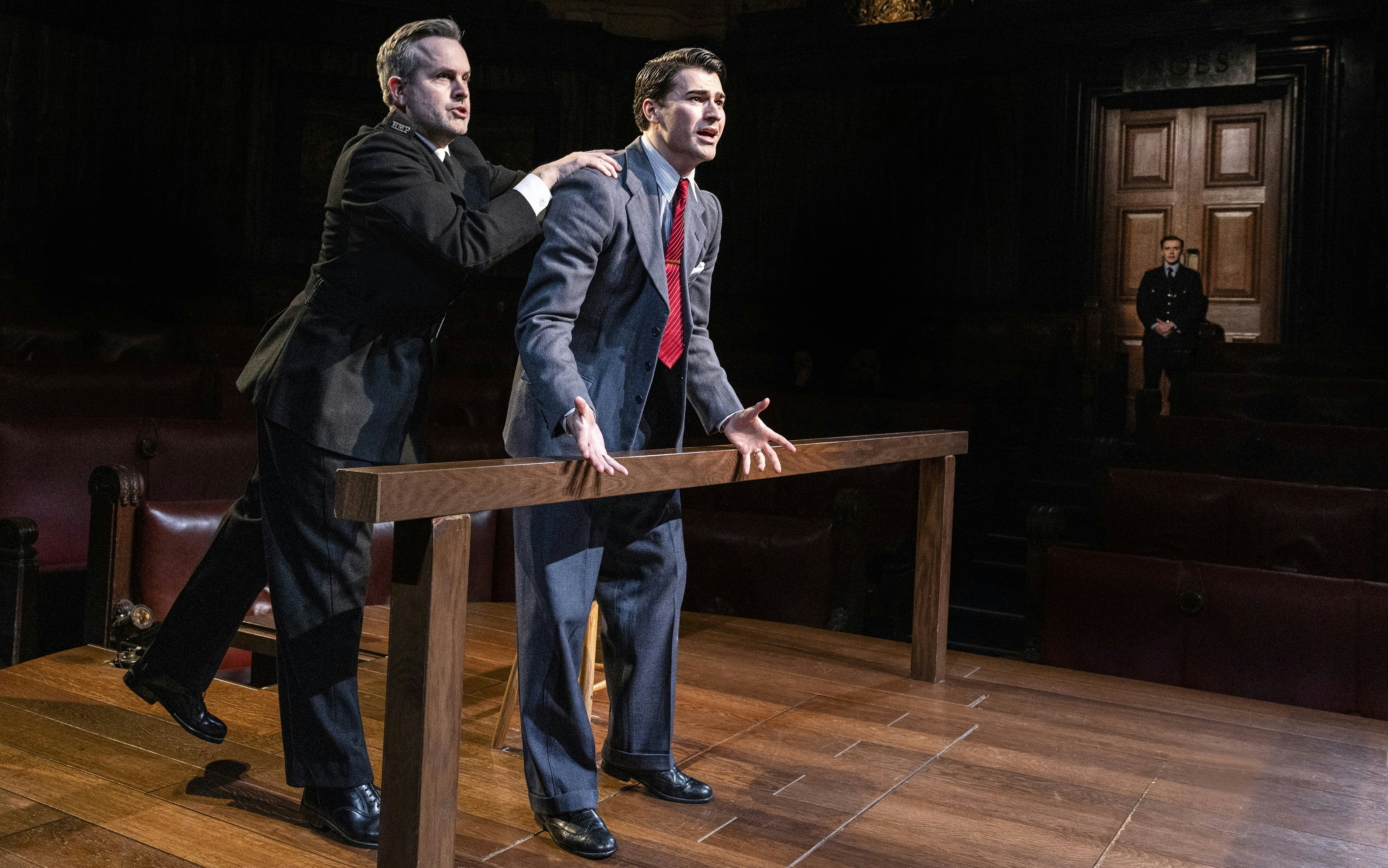 Courtroom scene from "Witness for the Prosecution" performance with actors in dramatic pose.