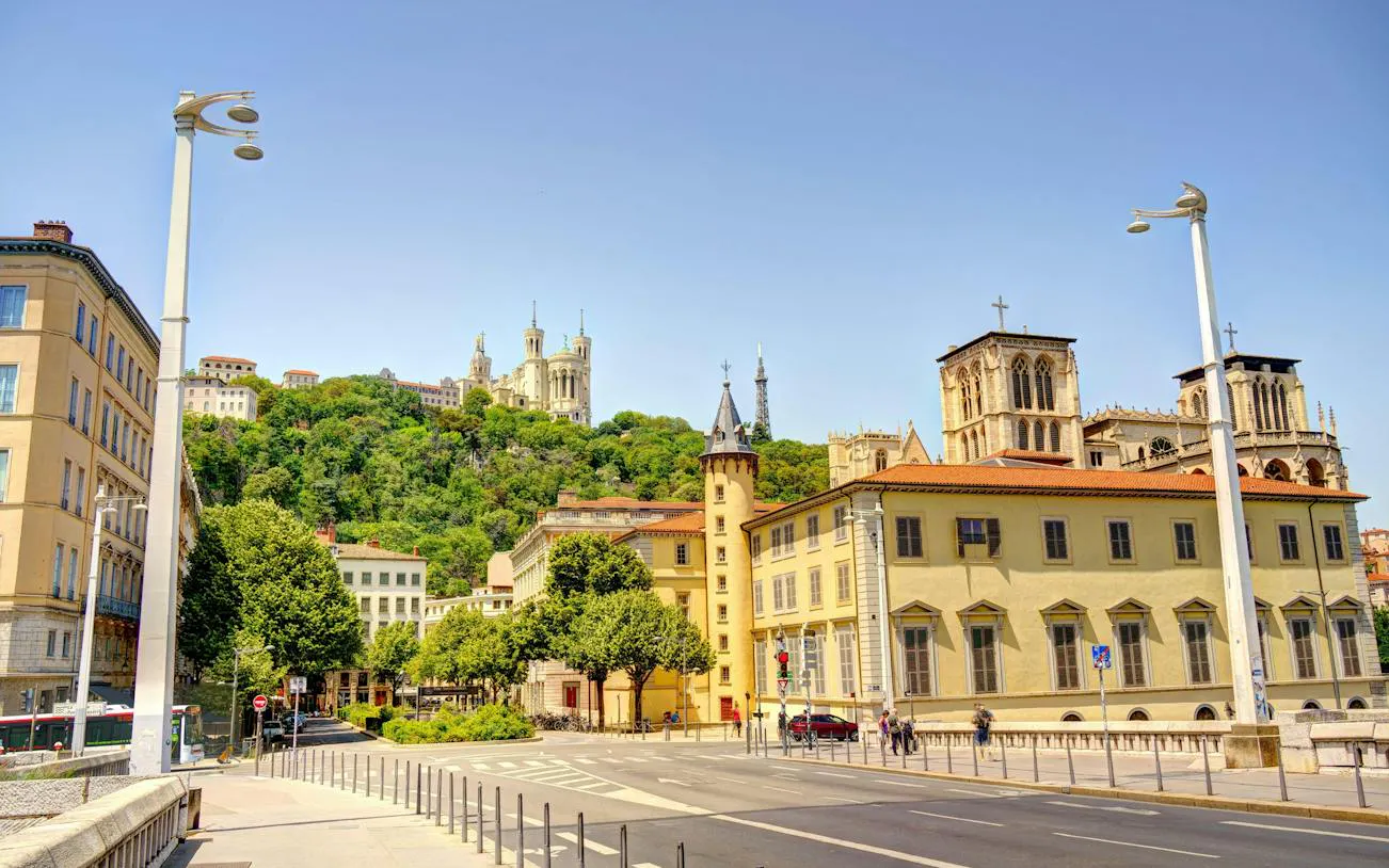 Lyon Old Town street view with Basilica of Notre-Dame de Fourvière on the hill.