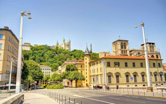 Lyon Old Town street view with Basilica of Notre-Dame de Fourvière on the hill.