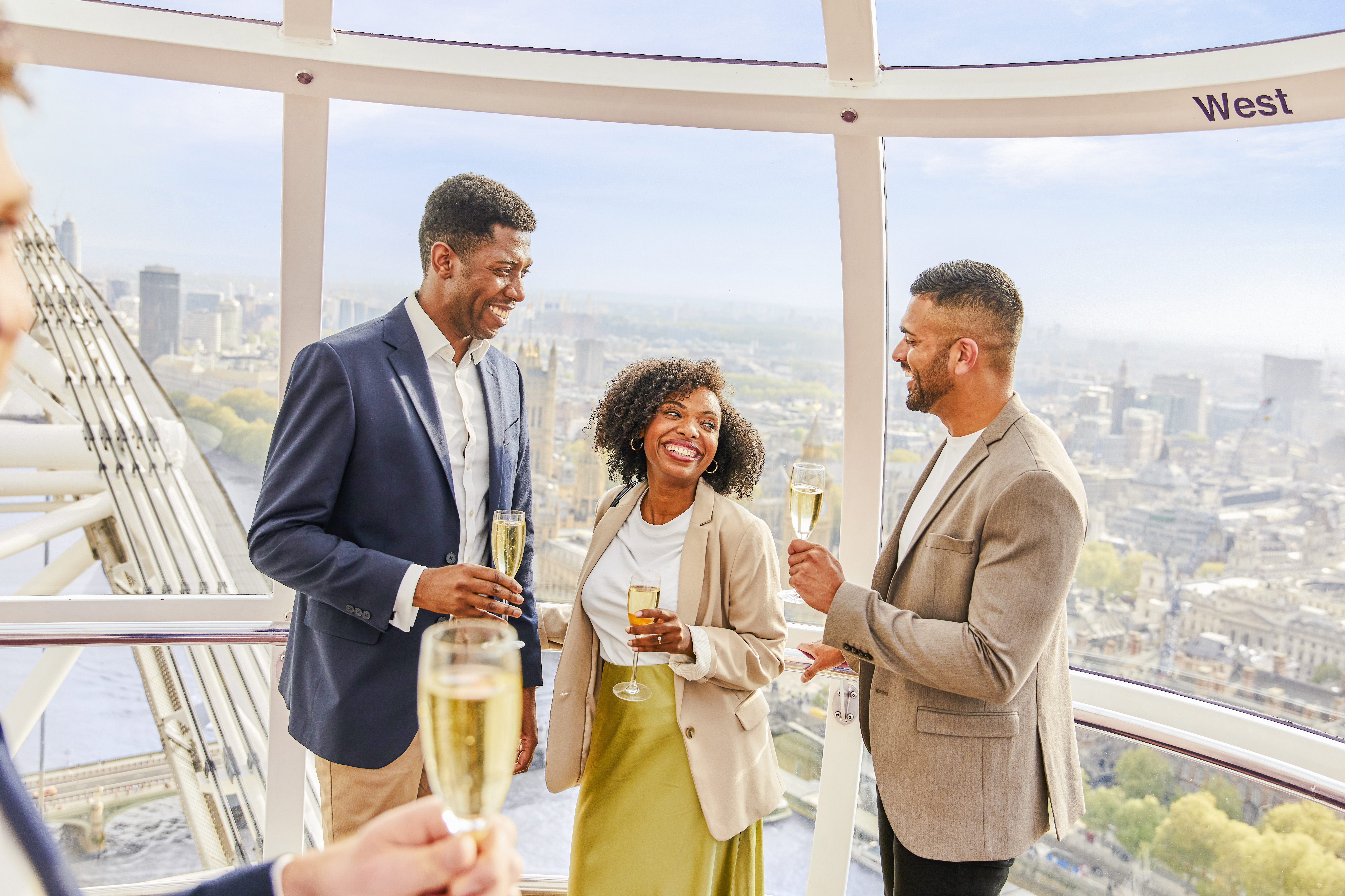 Guests enjoying champagne inside the London Eye capsule with city views.