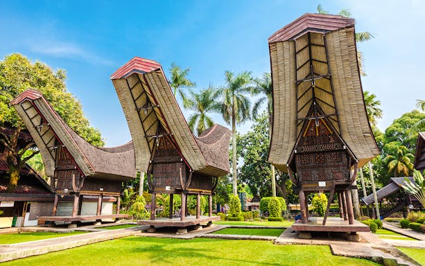 Traditional Indonesian houses with curved roofs at Taman Mini Indonesia.