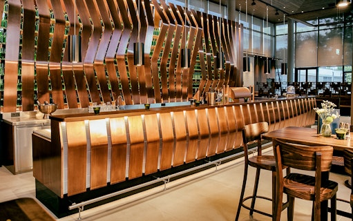 Bar area inside Donauturm Wien with modern copper design and seating.