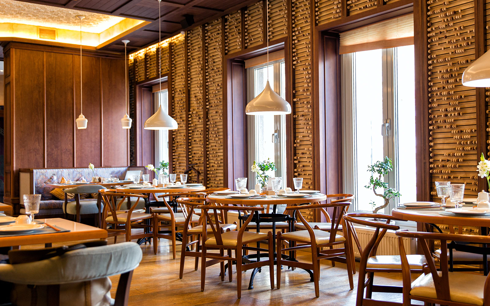 Cozy dining area in a London restaurant with wooden decor and elegant table settings.
