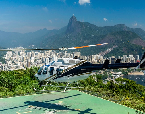 Helicopter taking off from Sugar Loaf Mountain, Rio de Janeiro, with Christ the Redeemer in view.