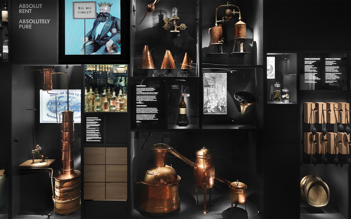 Stockholm museum exhibit showcasing historical distillation equipment and Absolut Vodka artifacts.