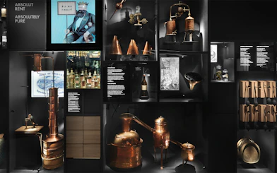 Stockholm museum exhibit showcasing historical distillation equipment and Absolut Vodka artifacts.