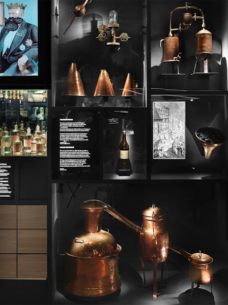 Stockholm museum exhibit showcasing historical distillation equipment and Absolut Vodka artifacts.