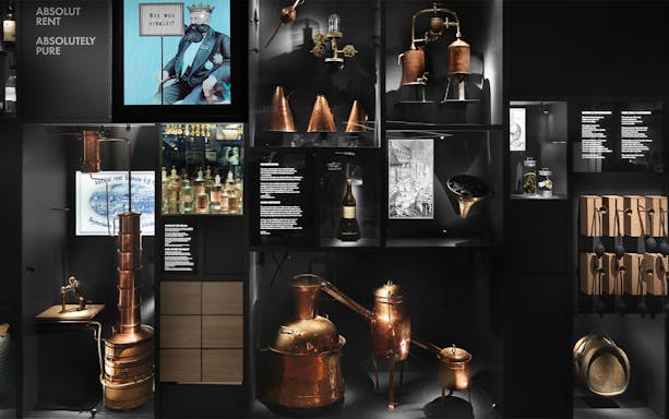 Stockholm museum exhibit showcasing historical distillation equipment and Absolut Vodka artifacts.