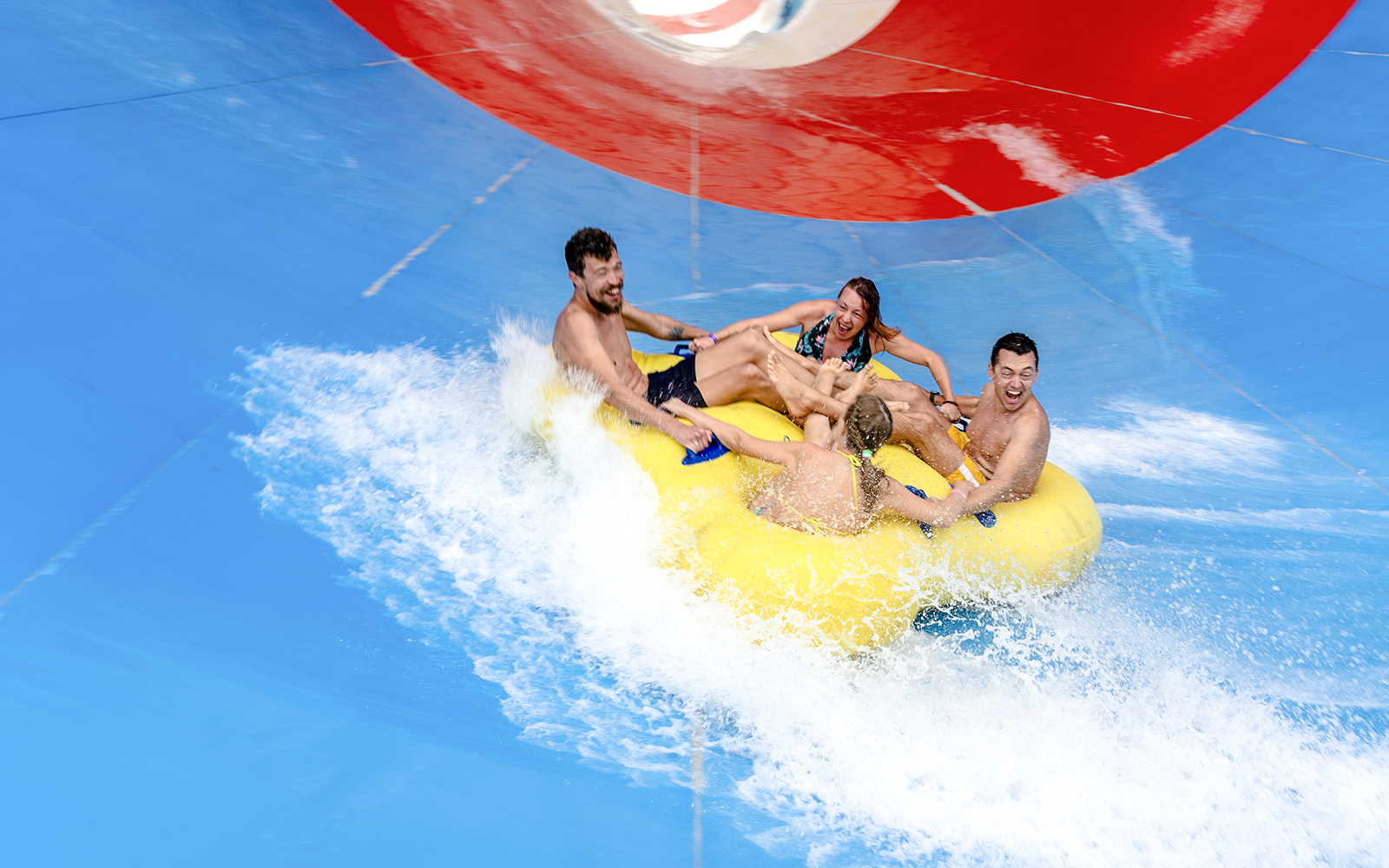 Friends enjoying a water slide ride at a water park.
