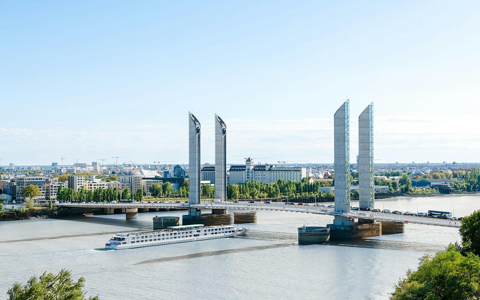 Pont Jacques Chaban Delmas bridge in Bordeaux with a boat passing underneath.