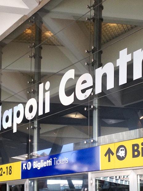 Naples Central Station entrance signage for train platforms and ticketing.