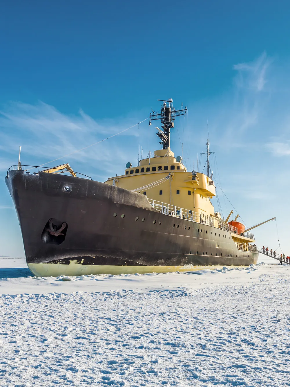 Icebreaker ship on frozen sea near Kemi, Rovaniemi, Finland with people boarding.