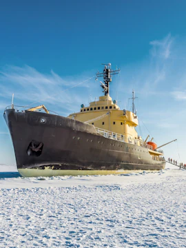 Icebreaker ship on frozen sea near Kemi, Rovaniemi, Finland with people boarding.