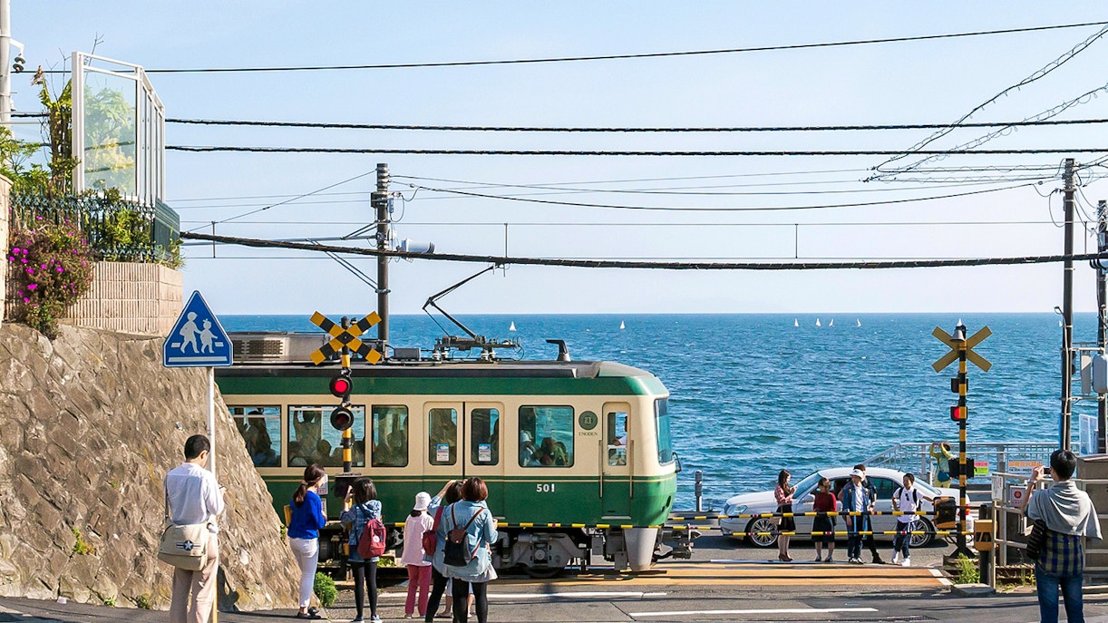 Enoden train passing by coastal scenery in Kanagawa, Japan.