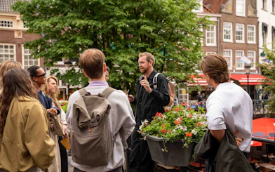 Group listening to guide during Utrecht walking tour with local stories.